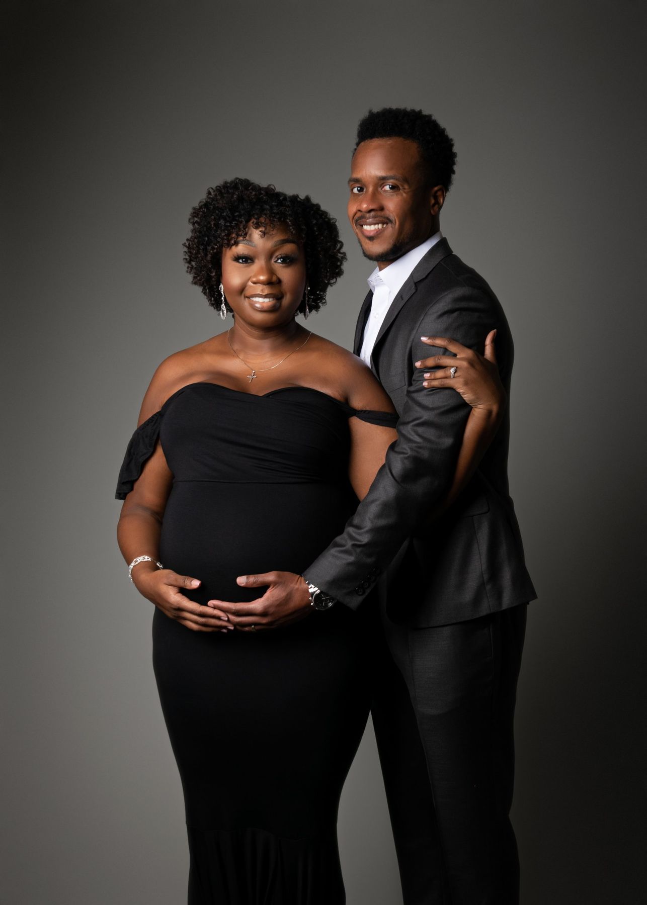 Formal maternity couple portrait in black