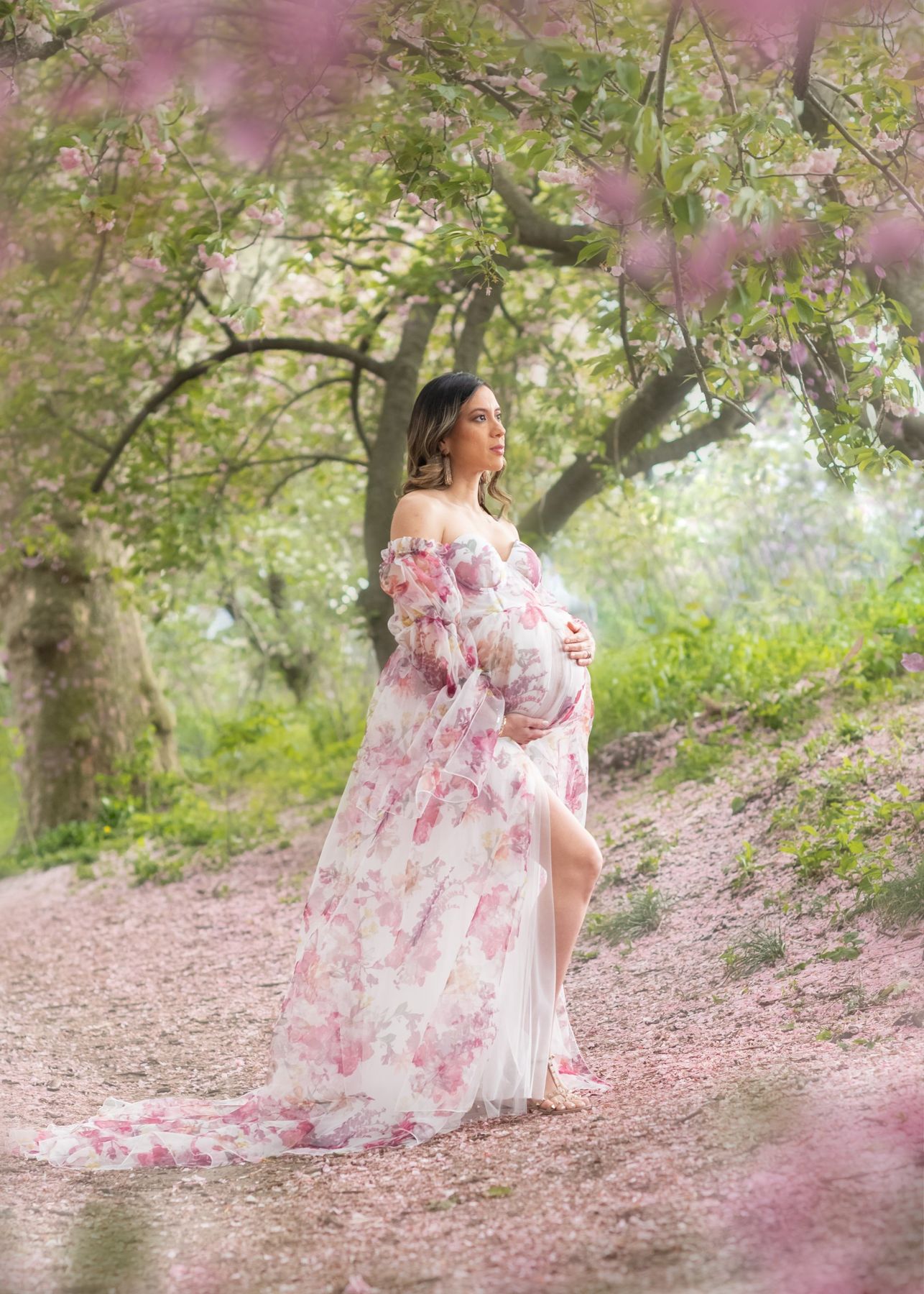 Outdoor maternity portrait under blossoming trees